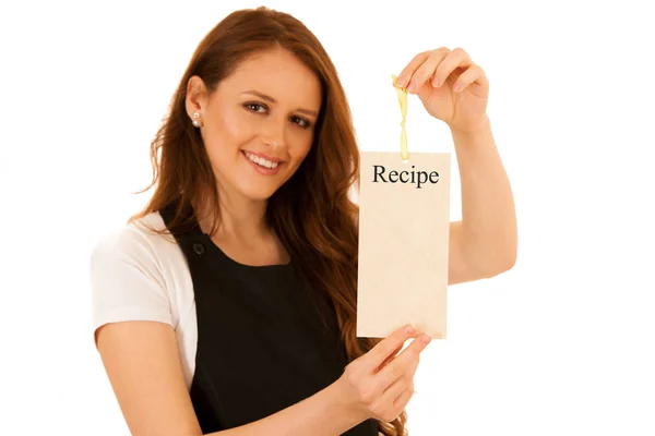 Mulher chef bonita segurando um cartão com receita isolada sobre wh — Fotografia de Stock