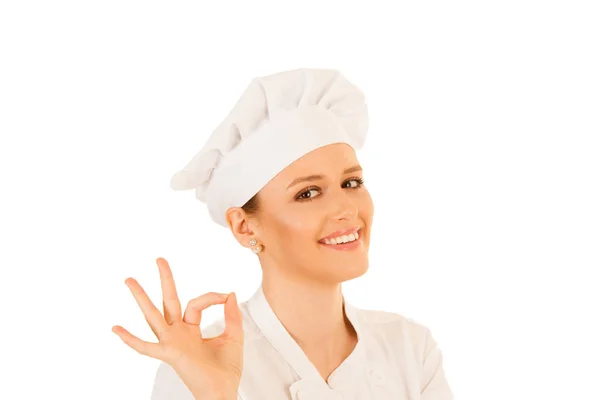 Bonito jovem chef mulher gestos excelente isolado sobre branco — Fotografia de Stock