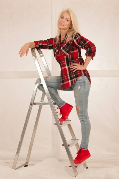 Fashion shots of a cute blonde woman with ladder — Stock Photo, Image