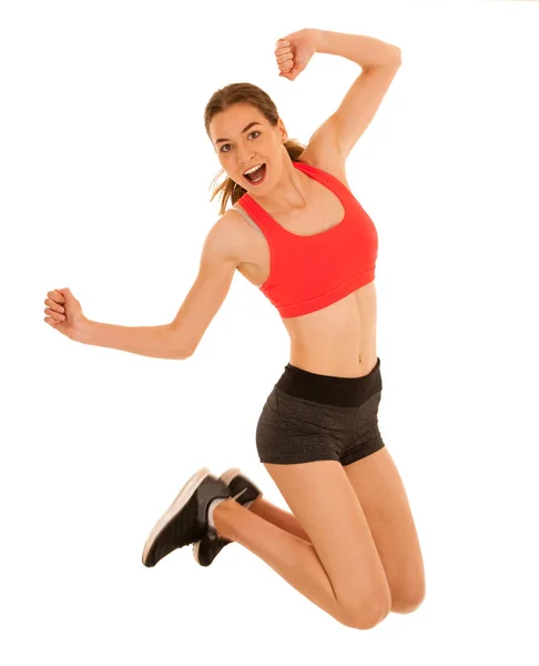 Attraktive sportliche Frau springt über weißen Hintergrund — Stockfoto