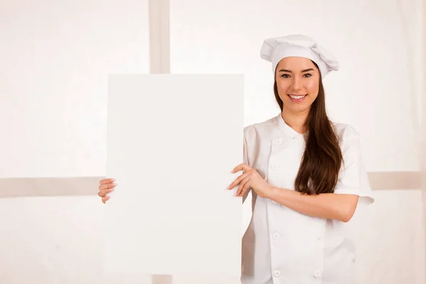 Young blonde chef woamn holds kitchenware as she prepares to coo — Stock Photo, Image