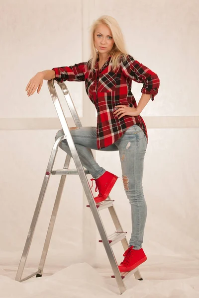 Fashion shots of a cute blonde woman with ladder — Stock Photo, Image