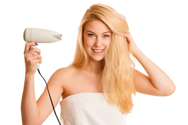 Blonde woman drieing her hair with air blower isolated over whit — Stock Photo, Image