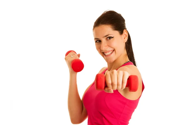 Aktive junge Frau turnt mit Kurzhanteln in Fitnessstudio — Stockfoto