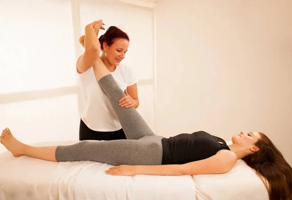 Fisioterapia-terapeuta haciendo ejercicio con el paciente, trabajando en le —  Fotos de Stock