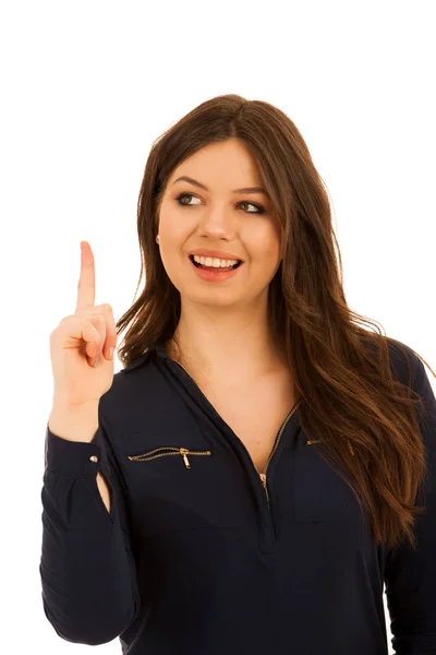 Attractive young woman pointing to copy space isolated over whit — Stock Photo, Image
