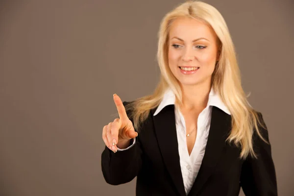 Beautiful business woman presing avirtual button on a transparen — Stock Photo, Image