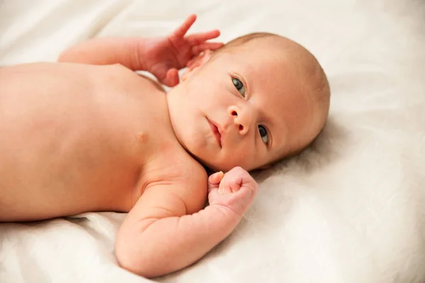 Newborn child lying on bed — Stock Photo, Image