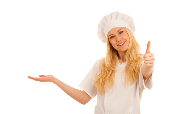 Young blonde chef points to copy space as she presents a new rec — Stock Photo, Image