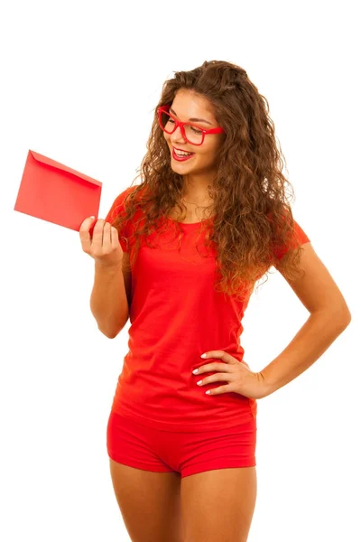 Beautiful young woman in red holding red envelope — Stock Photo, Image