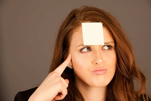 Business woman with a sticker on her forehead — Stock Photo, Image