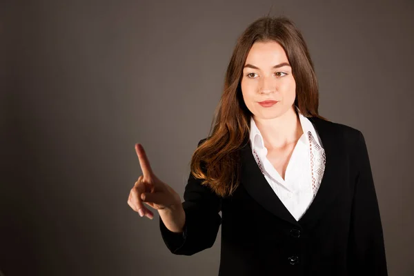 Attractive young business woman pressing virtual button over gra — Stock Photo, Image