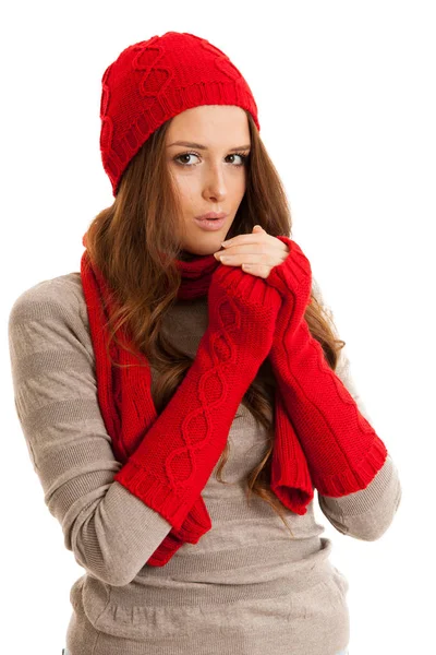 Beautiful young woman in sweater, hat and scarf gestures cold te Royalty Free Stock Images