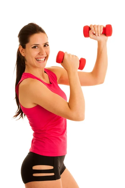 Aktive junge Frau turnt mit Kurzhanteln in Fitnessstudio — Stockfoto