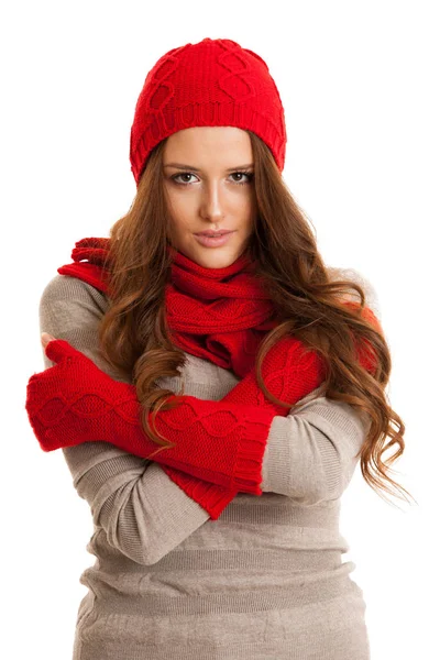 Beautiful young woman in sweater, hat and scarf gestures cold te — Stock Photo, Image