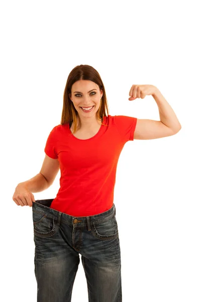 Mooie jonge vrouw geldt ook grote broek als ze gewicht verloren — Stockfoto