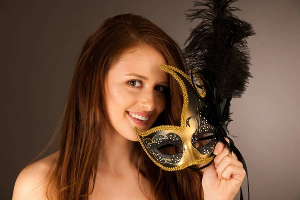Atractive young woman with venice mask studio portrait — Stock Photo, Image