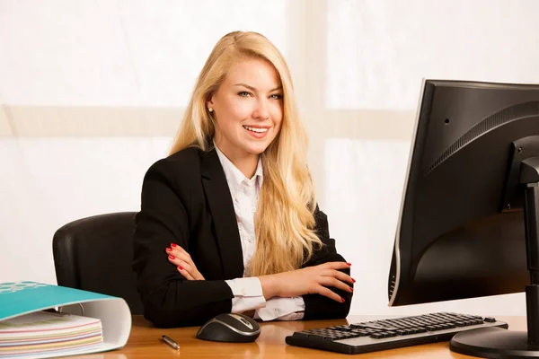 年轻漂亮的金发女郎在办公室里用电脑工作 — 图库照片