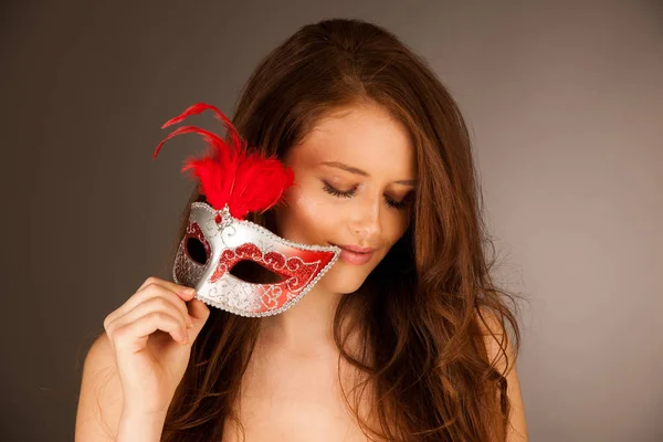 Atractive young woman with venice mask studio portrait — Stock Photo, Image