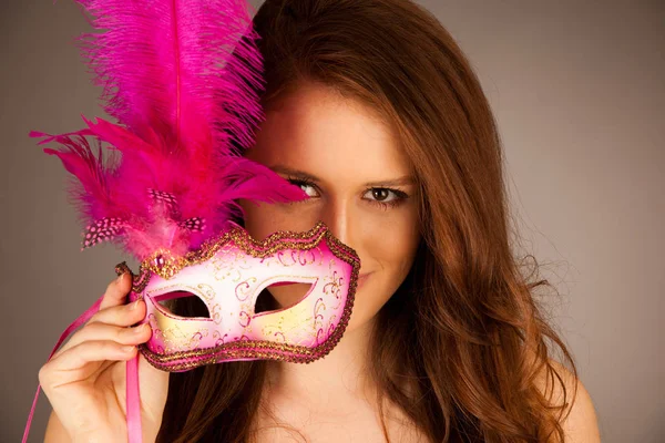 Atractive young woman with venice mask studio portrait Stock Photo