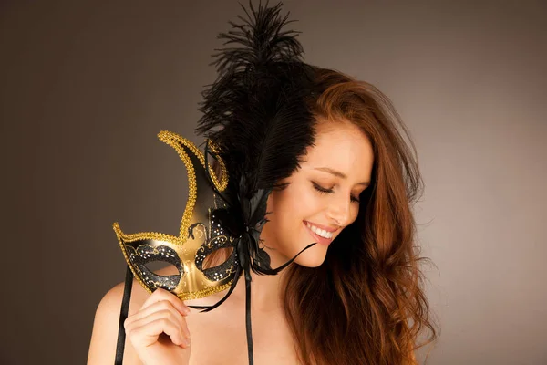 Atractive young woman with venice mask studio portrait — Stock Photo, Image