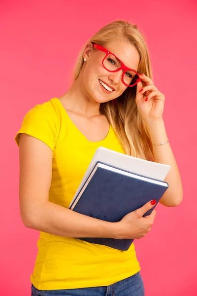 Beautiful young happy woman in yellow t shirt holds folder pose — Stock Photo, Image