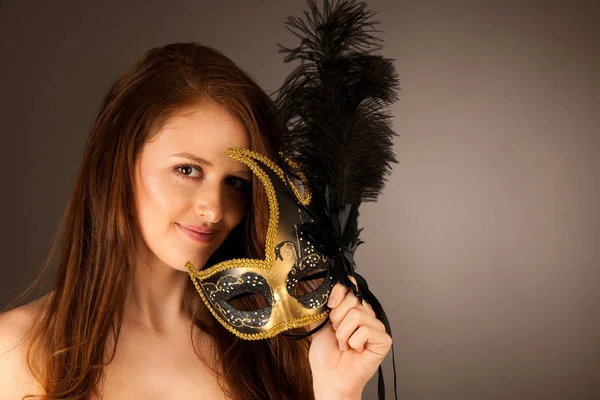 Atractive young woman with venice mask studio portrait Stock Image