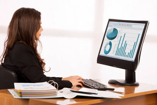 Beautiful young brunette business woman work in her office — Stock Photo, Image