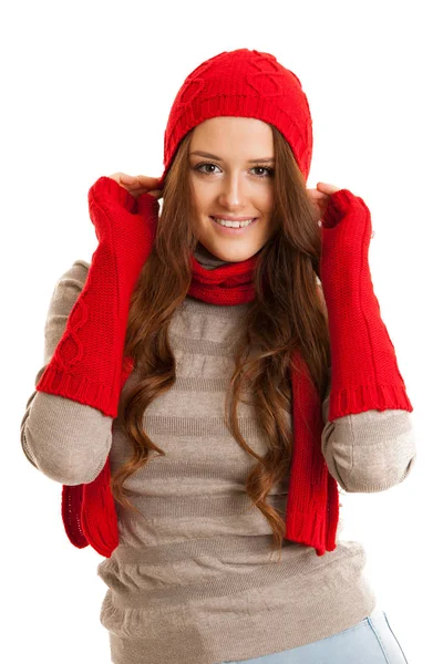 Beautiful young woman in sweater, hat and scarf gestures cold te Royalty Free Stock Photos