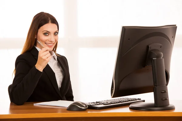 Aantrekkelijke jonge zakenvrouw werkt bij haar Bureau in het kantoor — Stockfoto