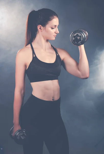 Активна молода спортивна іспаномовна жінка тренується з гантелями ізолат — стокове фото