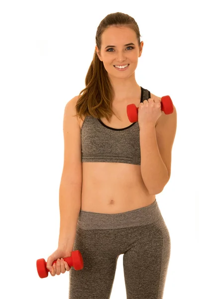 Beautiful young fit woman works out with dumbbells isolated over — Stock Photo, Image