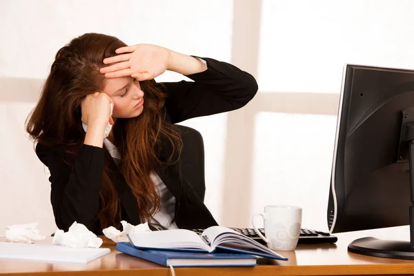 Il mulher sofrendo no trabalho atrás da mesa em seu escritório — Fotografia de Stock