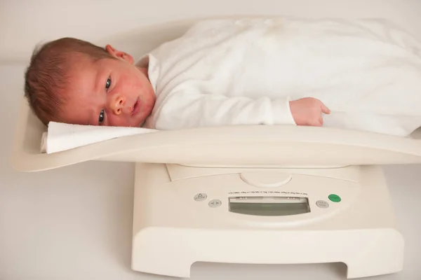 Bambino neonato di dieci giorni su una bilancia che misura il peso — Foto Stock