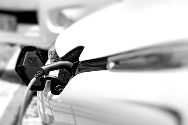 Cable hanging down from gas tank location on electrical vehicle. Stock Photo