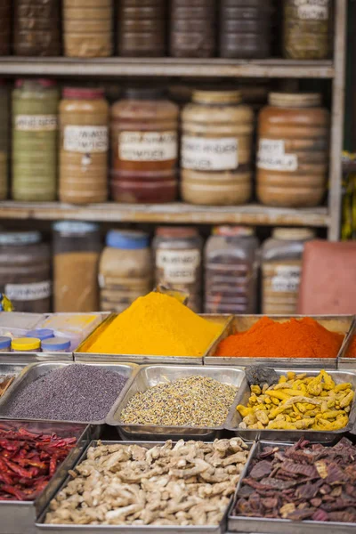 Jars of herbs and powders in a indian spice shop.