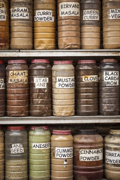 Jars of herbs and powders in a indian spice shop.