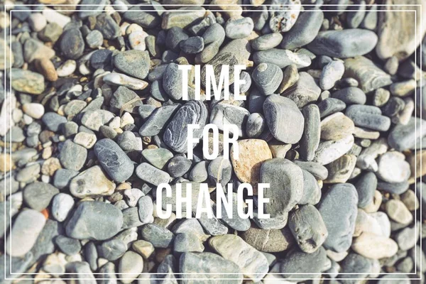 Word Time for Change.Sea stones as background.