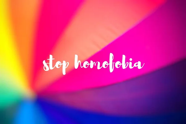 Stop homofobia. Rainbow coloured umbrella.