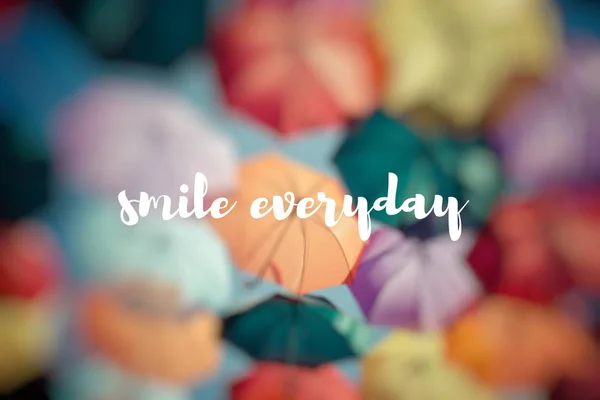 Smile everyday. Background colorful umbrella street decoration. — Stock Photo, Image