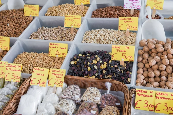 Veel verschillende kleurrijke kruiden, noten en gedroogde vruchten op de markt — Stockfoto