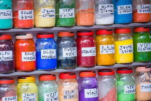 Assortment of glass jars on shelves in herbalist shop on a tradi — Stock Photo, Image