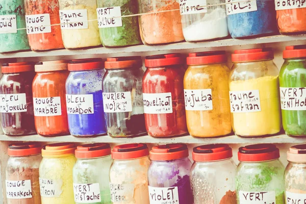 Assortment of glass jars on shelves in herbalist shop on a tradi — Stock Photo, Image