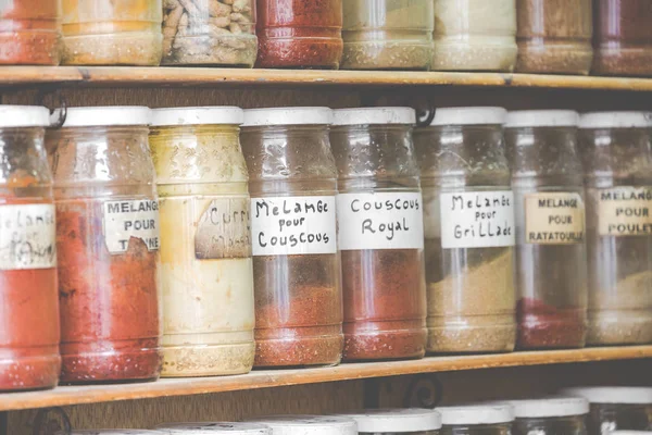 Assortment of glass jars on shelves in herbalist shop on a tradi — Stock Photo, Image