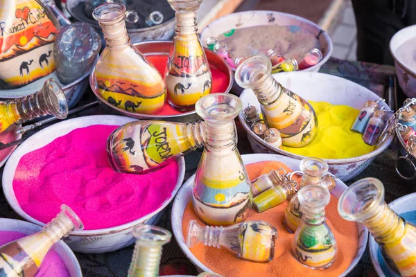 Souvenirs from Jordan - bottles with sand and shapes of desert a — Stock Photo, Image