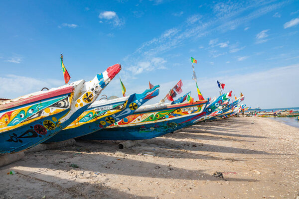 Traditional painted wooden fishing boat in Djiffer, Senegal. Wes