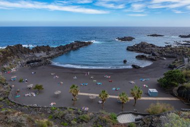 Tropical cactus garden and black sand beach at Los Cancajos. La 