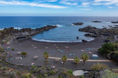 Tropical cactus garden and black sand beach at Los Cancajos. La  clipart