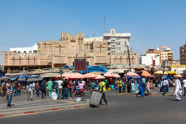 DAKAR, SENEGAL - NOVEMBER 11, 2019: People working and traffic at Senegal capital Dakar, West Africa.