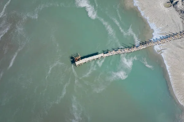 Aerial view of surrealistic industrial place. Dry surface. Desertic landscape. Human impact on the environment. View from above. Abstract industrial background. Photo made by drone.